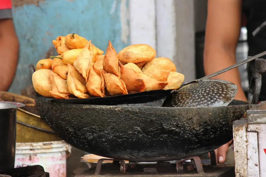 Samosa Chaat Delight combining crunchy samosa pieces with tangy chutneys, a unique vegetarian street food experience-Vegetarian Street Food Recipes