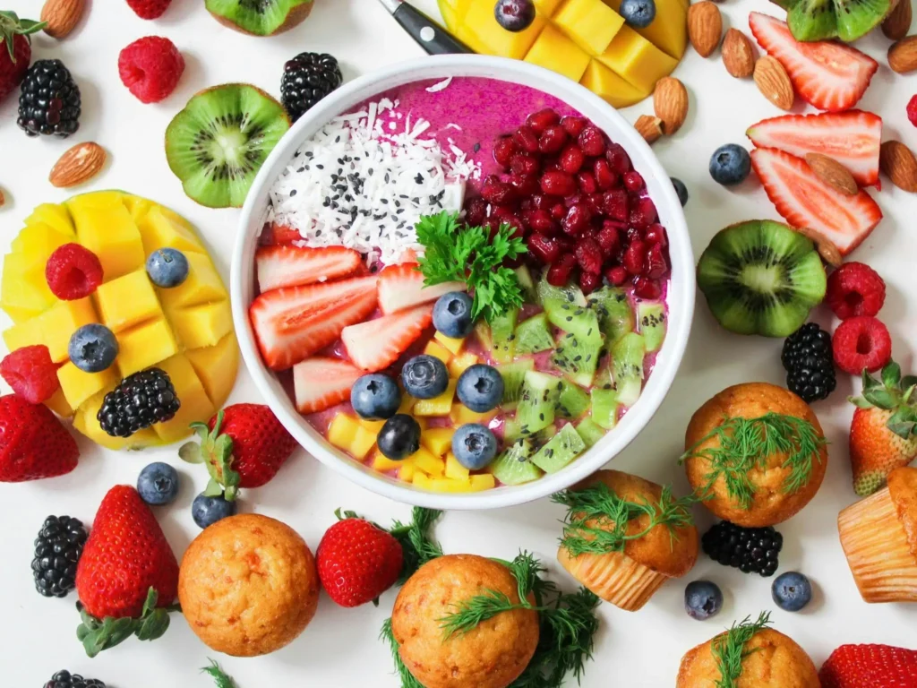 Fresh seasonal fruits including apples, pears, mixed berries, and almonds for a nutritious snack.