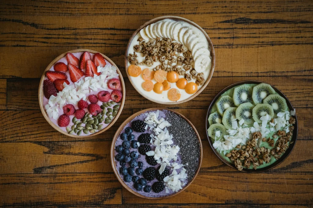 Vibrant smoothie bowl topped with berries, seeds, and coconut from a food truck